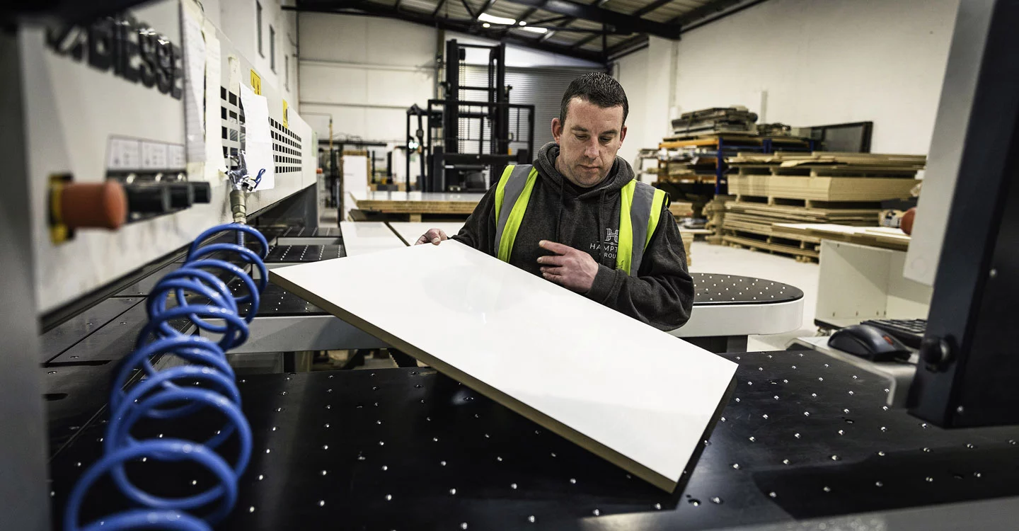 photograph-of-man-inspecting-panel-element